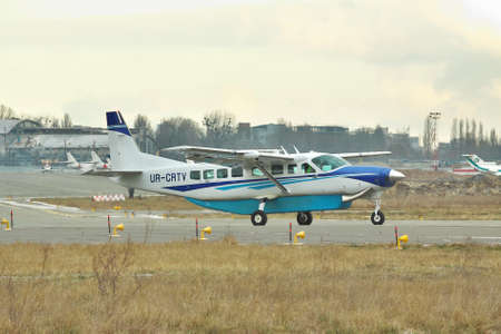 Kiev, Ukraine - December 24, 2011: Cessna 208 Grand Caravan regional plane is taxiing to the runway...