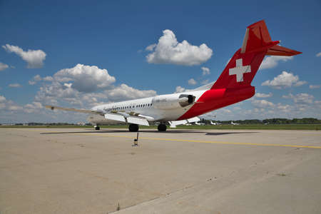 Borispol, Ukraine - July 5, 2014: Helvetic Airways Fokker-100 passenger plane taxiing to the terminal after landing - rear viewのeditorial素材