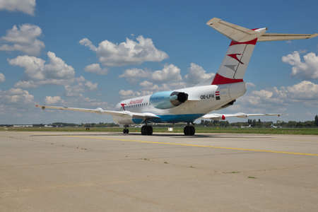 Borispol, Ukraine - July 5, 2014: Austrian Airlines Fokker-70 passenger plane taxiing to the terminal after landing - rear viewのeditorial素材