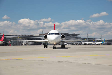Borispol, Ukraine - July 5, 2014: Helvetic Airways Fokker-100 passenger plane taxiing along the...
