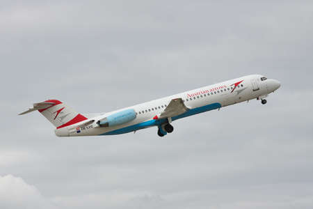 Borispol, Ukraine - October 2, 2010: Austrian Airlines Fokker 100 passenger plane is taking off into the cloudy sky for a next flightのeditorial素材