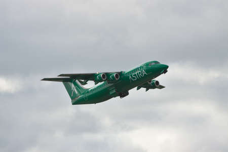 Borispol, Ukraine - October 2, 2010: Astra Airlines BAe 146 Avro RJ passenger plane is taking off into the cloudy sky while retracting gearのeditorial素材