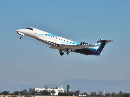Simferopol, Ukraine - September 12, 2010: Embraer EMB-135BJ business jet is taking off in the eveningのeditorial素材