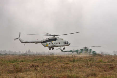 Zhitomir, Ukraine - September 29, 2010: Ukrainian Army military transport helicopters are landing in heavy storm during the military trainingsのeditorial素材