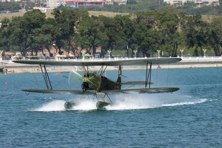 Gelendzhik, Russia - September 9, 2010: Polikarpov Po-2 vintage biplane is taxiing along the water surface after landingのeditorial素材