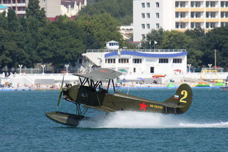 Gelendzhik, Russia - September 9, 2010: Polikarpov Po-2 vintage biplane is taking off from water surface of the bayのeditorial素材