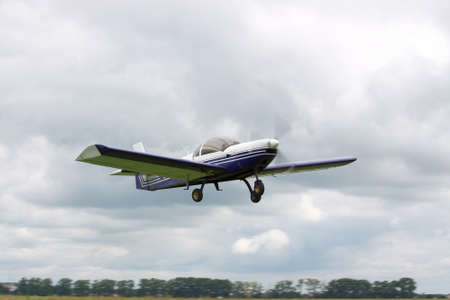 Small private plane is taking off into cloudy sky for a leisure flightの写真素材