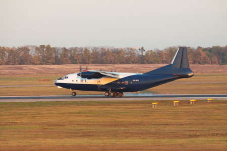 Kiev Region, Ukraine - October 23, 2011: Antonov An-12 cargo plane is touching down on the runway on...