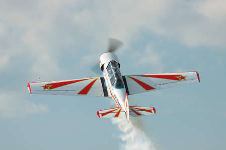Zhitomir, Ukraine - June 17, 2011: Yakovlev Yak-52 light trainer and aerobatic plane is performing the loopのeditorial素材