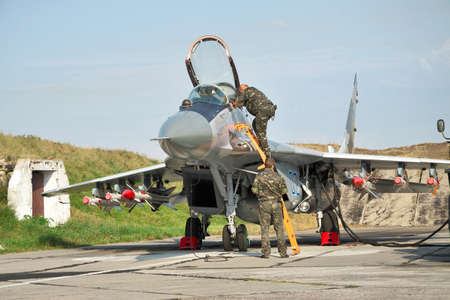 Vasilkov, Ukraine - August 3, 2012: Ukrainian Air Force Mig-29 fighter plane is being prepared for a training flight with weaponsのeditorial素材