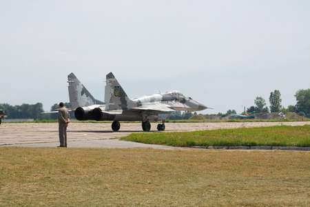 Vasilkov, Ukraine - August 3, 2012: Ukrainian Air Force Mig-29 fighter plane in gray paintscheme is taxiing to the runway for takeoffのeditorial素材