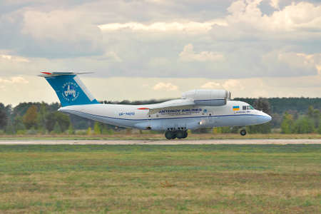 Kiev Region, Ukraine - October 3, 2010: Antonov An-74 cargo plane is taking off on stormy sunset - side viewのeditorial素材