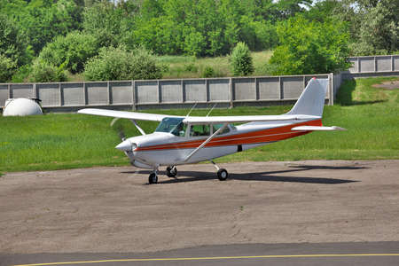 Light private plane is starting the engine on the parking of a private airfield for a leisure flightの写真素材