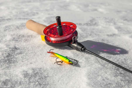 Ice fishing rod and lure closeup on the snowの写真素材