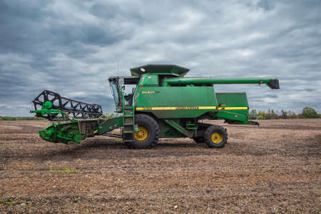 Kiev Region, Ukraine - October 6, 2013: John Deere 9610 Maximizer combine harvester on the field after soybean harvesting with cloudy sky on the backgroundのeditorial素材