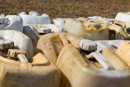 Canisters with fuel or other chemicals on the fieldの写真素材