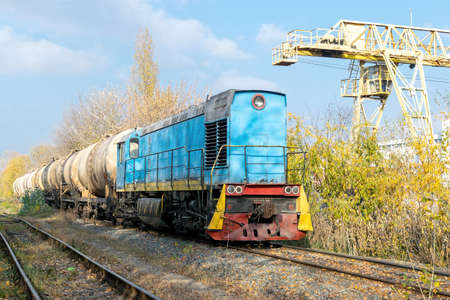 Diesel locomotive delivering oil in tanks in the industrial areaの写真素材