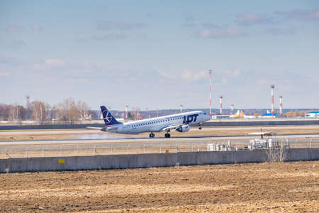 Kyiv, Ukraine - March 17, 2019: LOT Polish Airlines Embraer ERJ-195 on short final landing in the airportのeditorial素材
