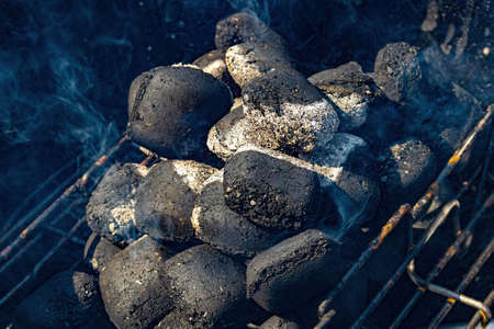 Hot barbecue coals being fired closeup backgroundの写真素材