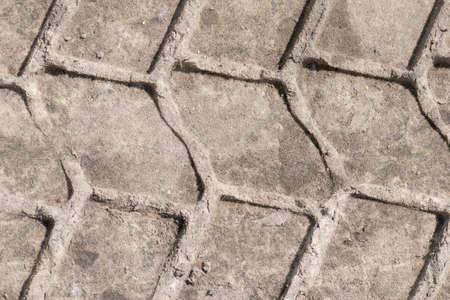 Track of a heavy truck tire on the wet ground surfaceの写真素材