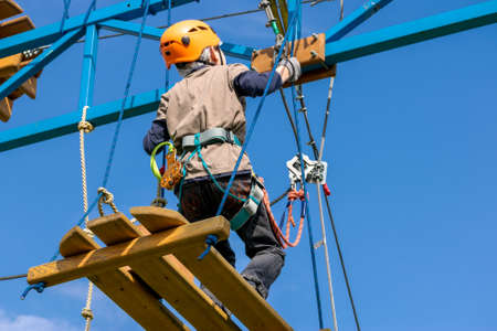 Boy practicing his climbing skills in a rope park