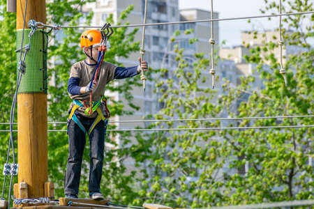Boy practicing his climbing skills in a rope parkの写真素材