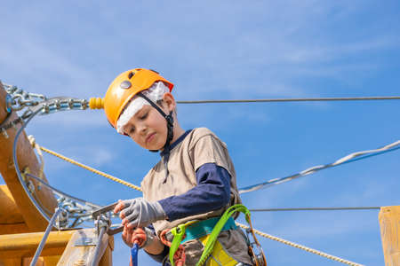 Boy practicing his climbing skills in a rope park