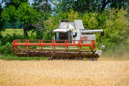Kyiv Region, Ukraine - July 6, 2019: Claas Lexion 480 combine harvester at work on the wheat fieldのeditorial素材