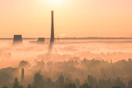 Heat power plant on sunrise with some fog in the valleyの写真素材