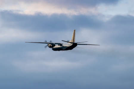 Turboprop cargo plane is taking off on sunsetの写真素材