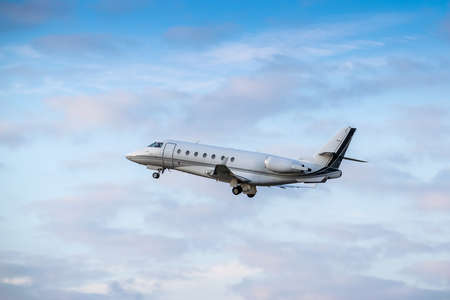 Business jet is taking off on sunsetの写真素材