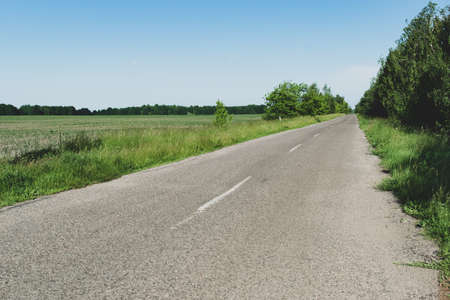 Lanscape with an empty asphalt country road old color photo effectの写真素材