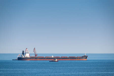 Bulk carrier ship is being loaded at seaの写真素材