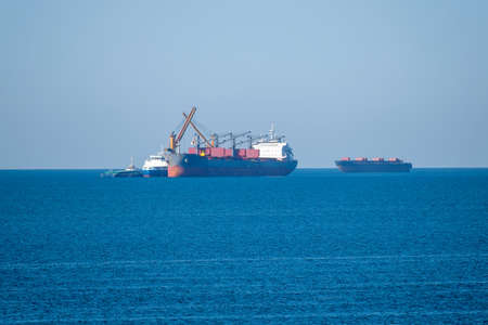 Bulk carrier is being loaded at seaの写真素材