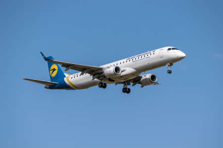 Boryspil, Ukraine - September 25, 2020: Ukraine International Airlines Embraer ERJ-195 is landing in the airportのeditorial素材