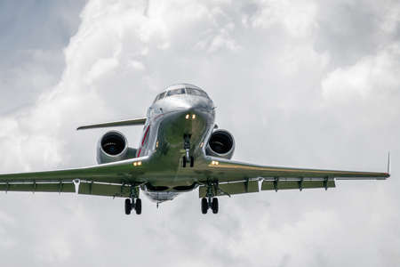 Business jet is landing on a cloudy dayの写真素材