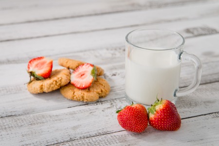 fresh healthy milk, strawberry and cookies on wooden backgroundの写真素材