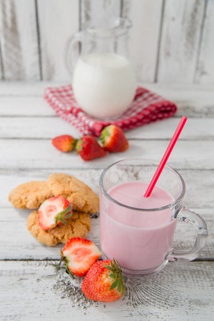 fresh healthy milk, strawberry and cookies on wooden backgroundの写真素材
