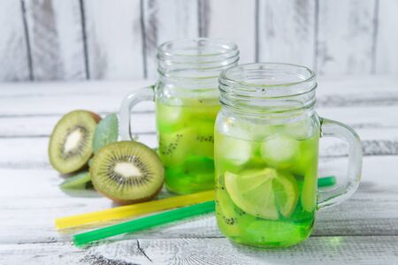 homemade lemonade with  kiwi, lemon, mint in glass on a wooden rustic tableの写真素材