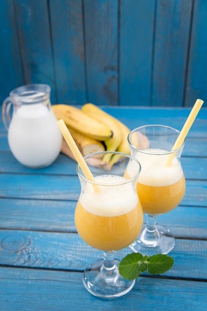 banana daiquiri in glass on a wooden rustic tableの写真素材