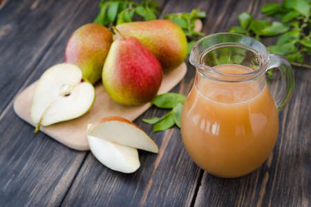fresh pear juice on a rustic wooden tableの写真素材