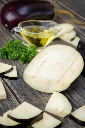 Fresh healthy eggplants on dark wooden background.の写真素材