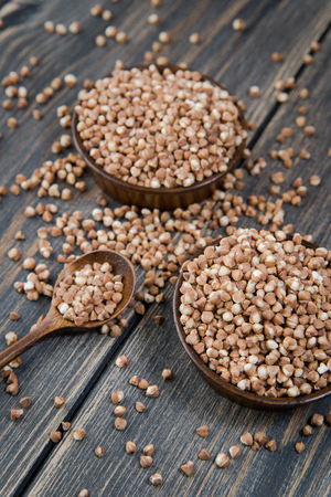 Dry buckwheat groats on an old wooden table, rustic styleの写真素材