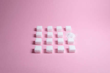 White sugar cubes on pink background composition. Minimal abstract food concept. White cubes.の写真素材
