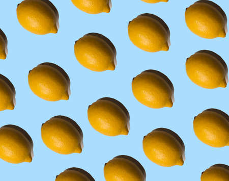 Multiplied lemons with shadows on pastel blue background. Tropical fruits.  Summer concept.の写真素材