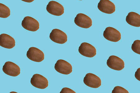 Kiwi fruit multiplied on trendy soft pastel blue background. Minimal healthy food, tropical fruits and summer concept.の写真素材