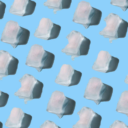 Ice cubes pattern on a trendy pastel blue background. Hot weather and summer idea. Minimal abstract refreshment concept.の写真素材