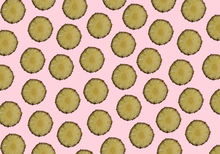 Randomly placed pineapple slices multiplied on trendy pastel pink background. Minimal summer...