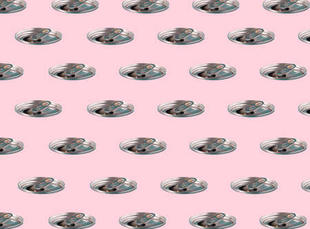 Top cap of a soda can multiplied on trendy soft pink background. Summer refreshment idea. Minimal abstract pollution and recycling concept. Pattern background. Copy space.の写真素材