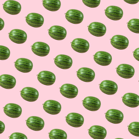 Trendy pink background with multiplied juicy watermelons. Minimal summer concept. With copy space.の写真素材